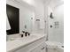 Bathroom with white vanity, quartz countertop, and a glass shower at 158 Mattoon St, Charlotte, NC 28216