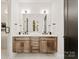 Double vanity bathroom with wood cabinets and marble countertop at 158 Mattoon St, Charlotte, NC 28216