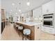 Modern kitchen with island, white cabinets, and stainless steel appliances at 158 Mattoon St, Charlotte, NC 28216