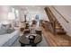Open concept living room with modern staircase and kitchen views at 158 Mattoon St, Charlotte, NC 28216
