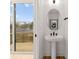Modern powder room with pedestal sink, and a view of a deck from sliding glass door at 158 Mattoon St, Charlotte, NC 28216