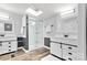 Contemporary bathroom with dual vanities, white cabinets, glass shower, and a skylight for natural light at 3107 Balkan Dr, York, SC 29745