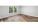 Sunlit bedroom features wood-look floors, a window with green views, and neutral paint at 3107 Balkan Dr, York, SC 29745