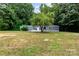 Charming single-story home with large front yard and mature trees, offering privacy and curb appeal at 3107 Balkan Dr, York, SC 29745