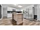 Bright kitchen boasts stainless appliances, white cabinets, skylight, wooden island, and stylish backsplash at 3107 Balkan Dr, York, SC 29745