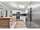 Well-lit kitchen with stainless steel appliances, wood island, granite countertops and plenty of storage at 3107 Balkan Dr, York, SC 29745