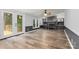 Open living room featuring wood floors, a decorative fireplace, recessed lights, and french doors to deck at 3107 Balkan Dr, York, SC 29745
