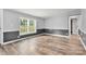 Open room with wood-look floors, windows, and two-tone wainscoting at 3107 Balkan Dr, York, SC 29745