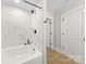 Modern bathroom with a tub-shower combo featuring elegant marble-look tile at 5319 Carden Dr, Charlotte, NC 28227