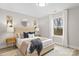 Bedroom with natural light features a bed with tufted headboard and matching side tables at 5319 Carden Dr, Charlotte, NC 28227