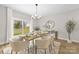 Bright dining room offers a view of the backyard, complete with modern table setting for a cozy meal at 5319 Carden Dr, Charlotte, NC 28227