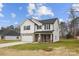 Charming two-story home showcasing modern design, light siding, and a welcoming covered front porch at 5319 Carden Dr, Charlotte, NC 28227