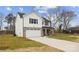 Stylish two-story home featuring a brick-accented garage, light siding, and welcoming covered front porch at 5319 Carden Dr, Charlotte, NC 28227