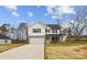 Inviting two-story home features a brick-accented facade, white siding, and a welcoming front porch at 5319 Carden Dr, Charlotte, NC 28227