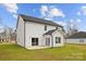 View of the home with sliding doors leading to a patio and a well-kept lawn at 5319 Carden Dr, Charlotte, NC 28227