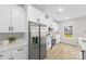 Modern kitchen with stainless steel appliances, white cabinets, and bright natural light at 5319 Carden Dr, Charlotte, NC 28227