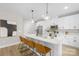 Modern kitchen with white cabinetry, stainless steel appliances, and a large island with seating at 5319 Carden Dr, Charlotte, NC 28227