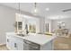 Well-lit kitchen with stainless steel appliances, white cabinets, and an island with seating at 5319 Carden Dr, Charlotte, NC 28227