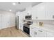 Contemporary kitchen featuring white cabinets, stainless steel appliances, and modern countertops at 5319 Carden Dr, Charlotte, NC 28227
