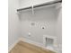 Practical laundry room with hookups and shelving for organization and storage at 5319 Carden Dr, Charlotte, NC 28227