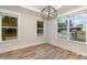 Sunlit breakfast nook boasts hardwood floors and expansive windows at 605 Julia Ave, Belmont, NC 28012