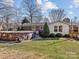 Fenced backyard features above ground pool, established landscaping and mature trees at 105 Victoria Dr, Statesville, NC 28625