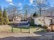 Fenced backyard features above ground pool, established landscaping and mature trees at 105 Victoria Dr, Statesville, NC 28625