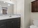 Bathroom with dark vanity, mosaic backsplash, and toilet at 105 Victoria Dr, Statesville, NC 28625