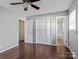 Bright bedroom features hardwood floors, white closets and doors, and neutral-colored walls at 105 Victoria Dr, Statesville, NC 28625