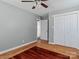 Bedroom with wood floors, white closets, neutral walls, and a modern ceiling fan at 105 Victoria Dr, Statesville, NC 28625