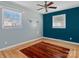 Bedroom with updated floors, a ceiling fan, natural light from two windows, and updated wall color at 105 Victoria Dr, Statesville, NC 28625