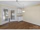 Inviting dining area with hardwood floors, glass doors and a stylish light fixture and built in cabinet at 105 Victoria Dr, Statesville, NC 28625