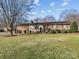 Brick ranch house with landscaped yard at 105 Victoria Dr, Statesville, NC 28625