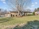 Well-maintained ranch with a brick facade, mature trees, and manicured landscaping at 105 Victoria Dr, Statesville, NC 28625