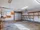 Spacious garage features a large roll-up door and wooden shelving on the walls at 105 Victoria Dr, Statesville, NC 28625