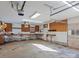 View of the home's garage featuring a large roll-up door and workbench at 105 Victoria Dr, Statesville, NC 28625