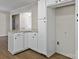 Well-lit kitchen featuring granite countertops, white cabinetry, and wood-look flooring at 105 Victoria Dr, Statesville, NC 28625