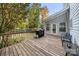 Wooden back deck with seating area and grill, overlooking a wooded yard at 2545 Rea Rd, Charlotte, NC 28226