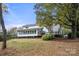 Expansive backyard view of the house with deck and surrounding greenery at 2545 Rea Rd, Charlotte, NC 28226