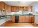 Wet bar area with wooden cabinetry, sink, and hardwood flooring at 2545 Rea Rd, Charlotte, NC 28226