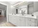 Bright bathroom featuring a double sink vanity with framed mirror and vanity lighting at 2545 Rea Rd, Charlotte, NC 28226