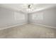 Bright bedroom featuring neutral carpet, white trim, and double windows at 2545 Rea Rd, Charlotte, NC 28226