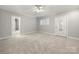 Neutral bedroom with plush carpeting, a door to an ensuite bathroom, and a glass front door at 2545 Rea Rd, Charlotte, NC 28226