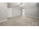 Neutral bedroom with plush carpeting, a ceiling fan, and a door to an ensuite bathroom at 2545 Rea Rd, Charlotte, NC 28226