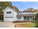 Traditional two-story home featuring a two car garage, covered front porch, and beautiful fall foliage at 2545 Rea Rd, Charlotte, NC 28226