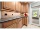 Kitchen area with stainless steel appliances, wood cabinetry, and tile backsplash at 2545 Rea Rd, Charlotte, NC 28226