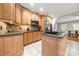 Kitchen area with stainless steel appliances, wood cabinetry, and tile floors at 2545 Rea Rd, Charlotte, NC 28226