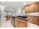 Kitchen area with stainless steel appliances, wood cabinetry, and island sink at 2545 Rea Rd, Charlotte, NC 28226