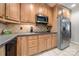 Kitchen area with stainless steel appliances, wood cabinetry, and tile backsplash at 2545 Rea Rd, Charlotte, NC 28226