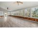 Bright sunroom with many windows, wood-paneled walls and a ceiling fan at 2545 Rea Rd, Charlotte, NC 28226